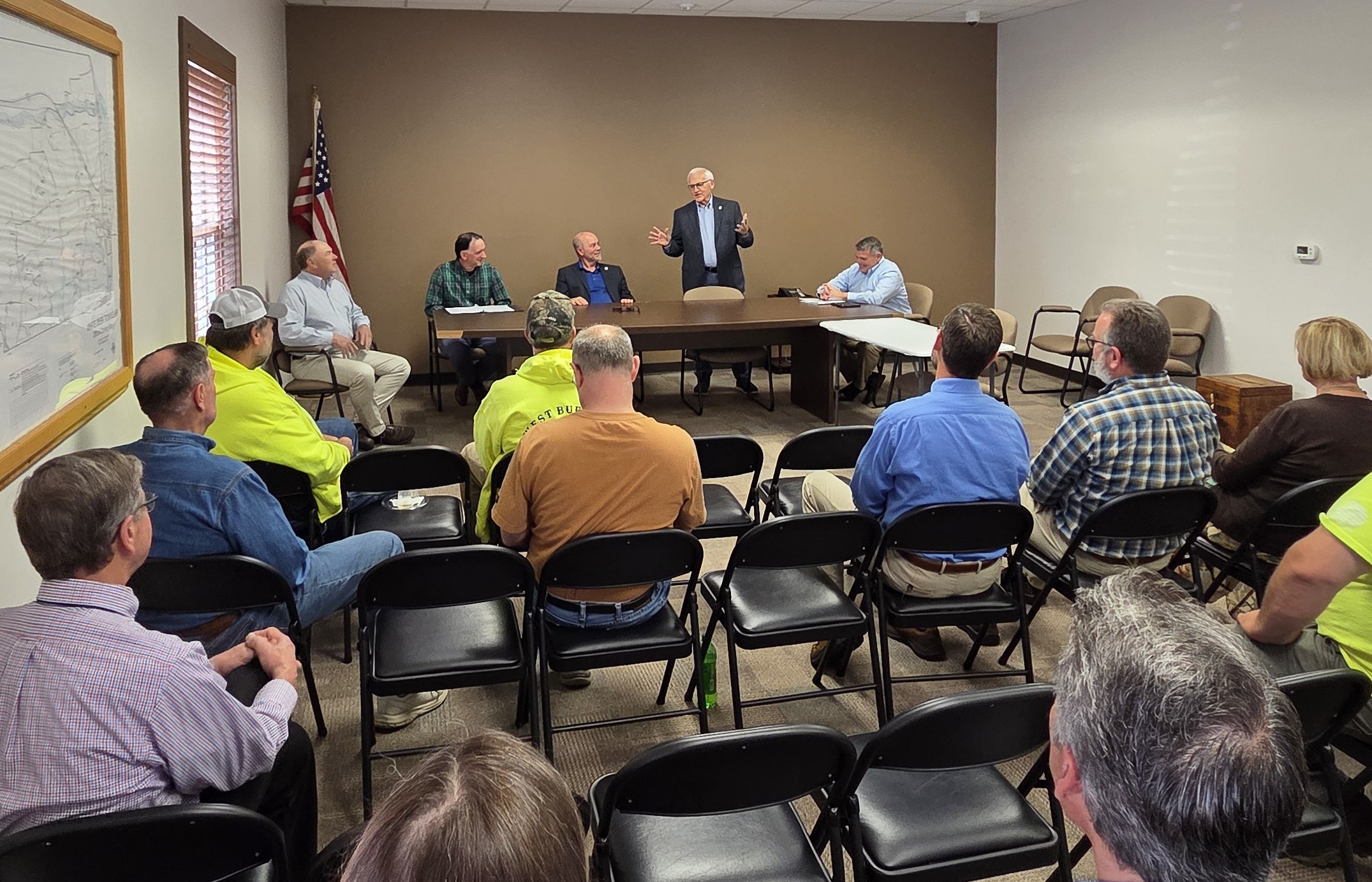 Sen. Yaw speaking to a group of individuals in a meeting room.