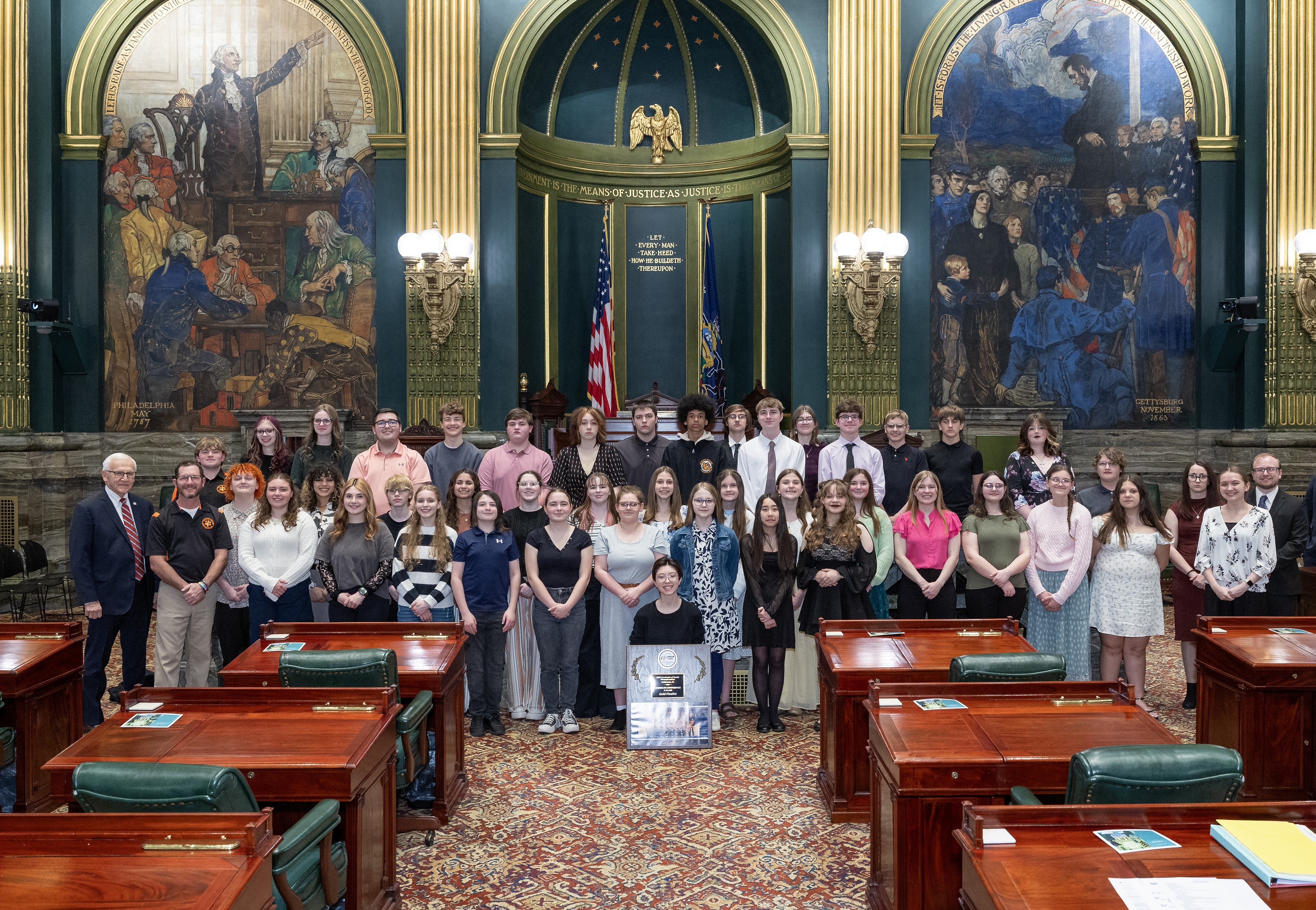 Sen. Yaw pictured on the Senate floor with the members of the Jersey Shore Marching Band along with their plaque for winning first place in the Cavalcade of bands championship 2025.