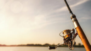 Close up of a fishing rod during the sunset with copy space