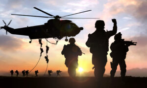 silhouette of military operation at sunset with sun glare