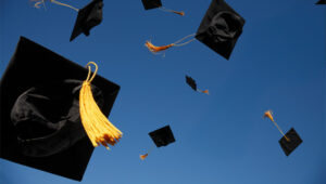 College graduation caps in the sky
