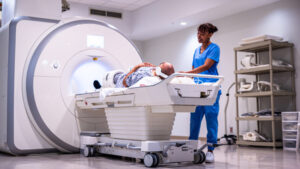 Young Female Radiologist prepares a hispanic male for his MRI