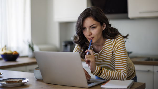 Young woman using a laptop while working from home