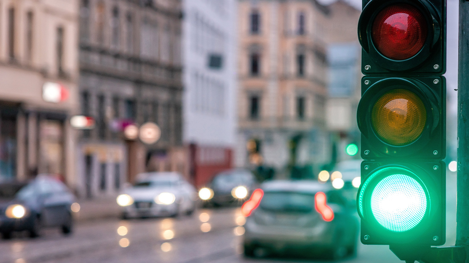 Red light in a busy intersection with the green light lit