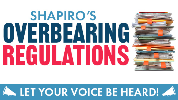 Stack of folders overflowing with paper, bullhorns and text reading “Shapiro’s Overbearing Regulations. Let your voice be heard.”