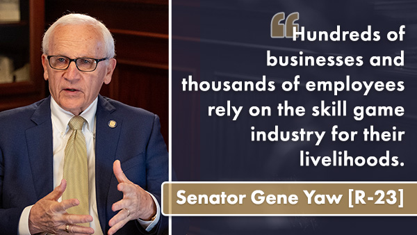 Yaw sitting indoors, wearing glasses, a dark blazer, and a light-colored tie, gesturing with one hand while speaking. Beside him is a graphic with a quote that reads, “Hundreds of businesses and thousands of employees rely on the skill game industry for their livelihoods,” with a highlighted nameplate below the quote.